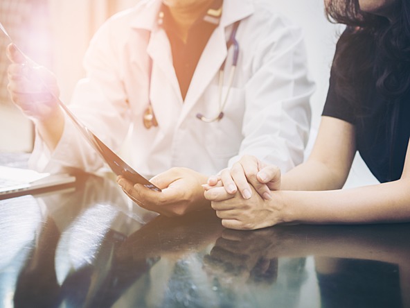 doctor in white coat and patient having a discussion 